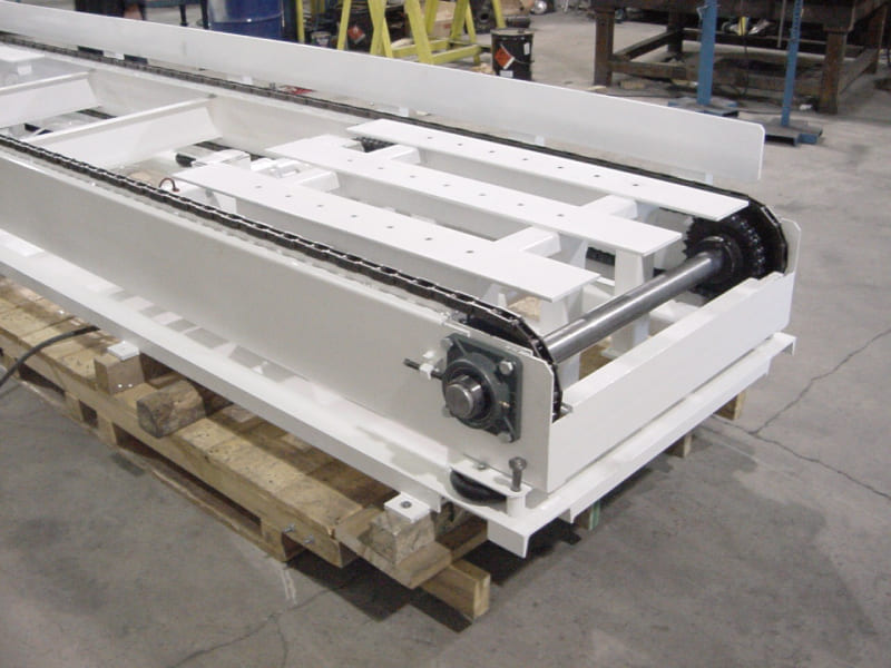 An image showing the white color galvanized chain conveyor system in modules for reference
